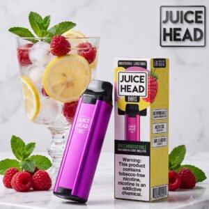 Image of the purple Juice Head 3000 Puffs Raspberry Lemonade disposable vape device and packaging, shown next to a glass of fresh lemonade and raspberries.